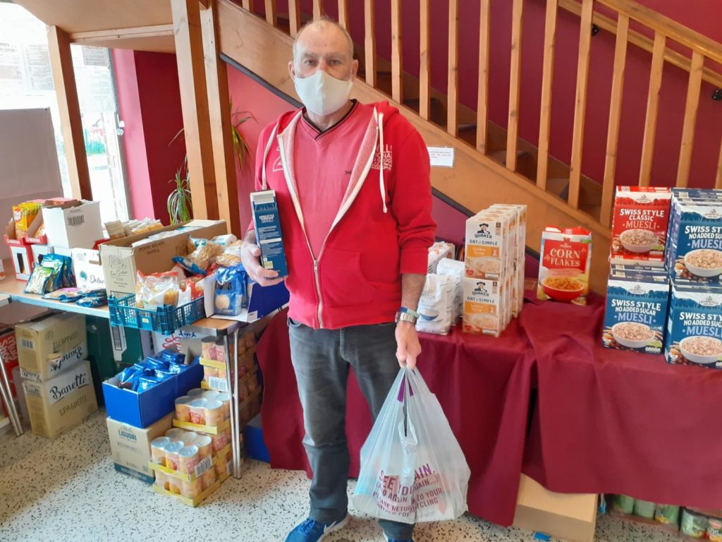 Resident with food in Roots Cafe