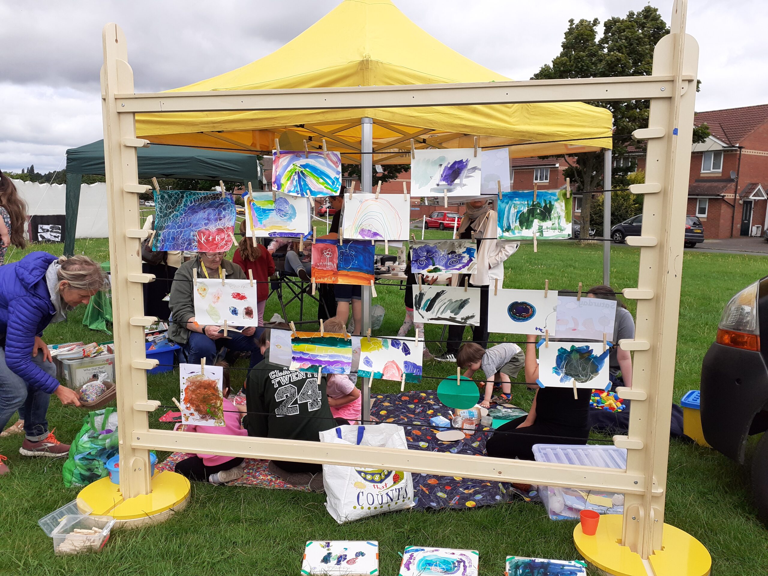 image shows drawings and artwork displayed on a stand in a playground