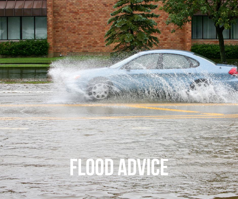 image of car driving through a flooded street